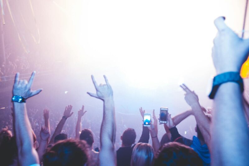 A lively nightclub scene with a vibrant crowd enjoying music and lights.